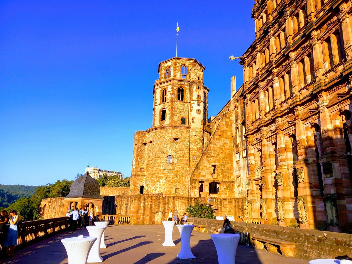 Heidelberg castle in the evening sun, the setting of the conference dinner. Some of the conference participants are pictured in the foreground.